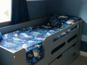 Grey Cabin bed with integrated drawers for storage.