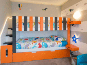 Trundle Bunk Bed with stairs and storage in modern bedroom. orange and black theme childrens bedroom