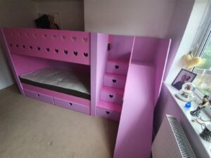 bunk bed with slide. drawers in the stairs. heart cut out. pink.