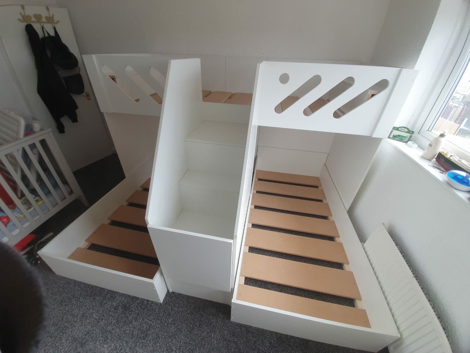 m shape triple bunk with gate on the stair case. in white. funky bunk beds design. single mattress size.