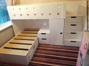 L-Shaped Bunk Beds with heart cut outs on top rail, drawers in the stairs, in white