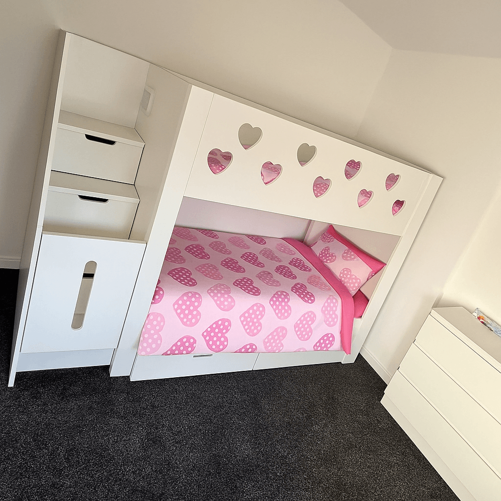 White wooden bunk bed with heart-shaped cutouts styled with the Love Hearts Children’s Duvet Cover Set, featuring pink polka-dot heart bedding in a modern kids’ bedroom with grey carpet and white furniture