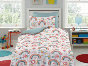 Rainbow Dreams Children’s Duvet Cover Set featuring colorful rainbows, sunshine, and flowers on a white background, styled on a single bed in a bright kids’ bedroom with playful décor